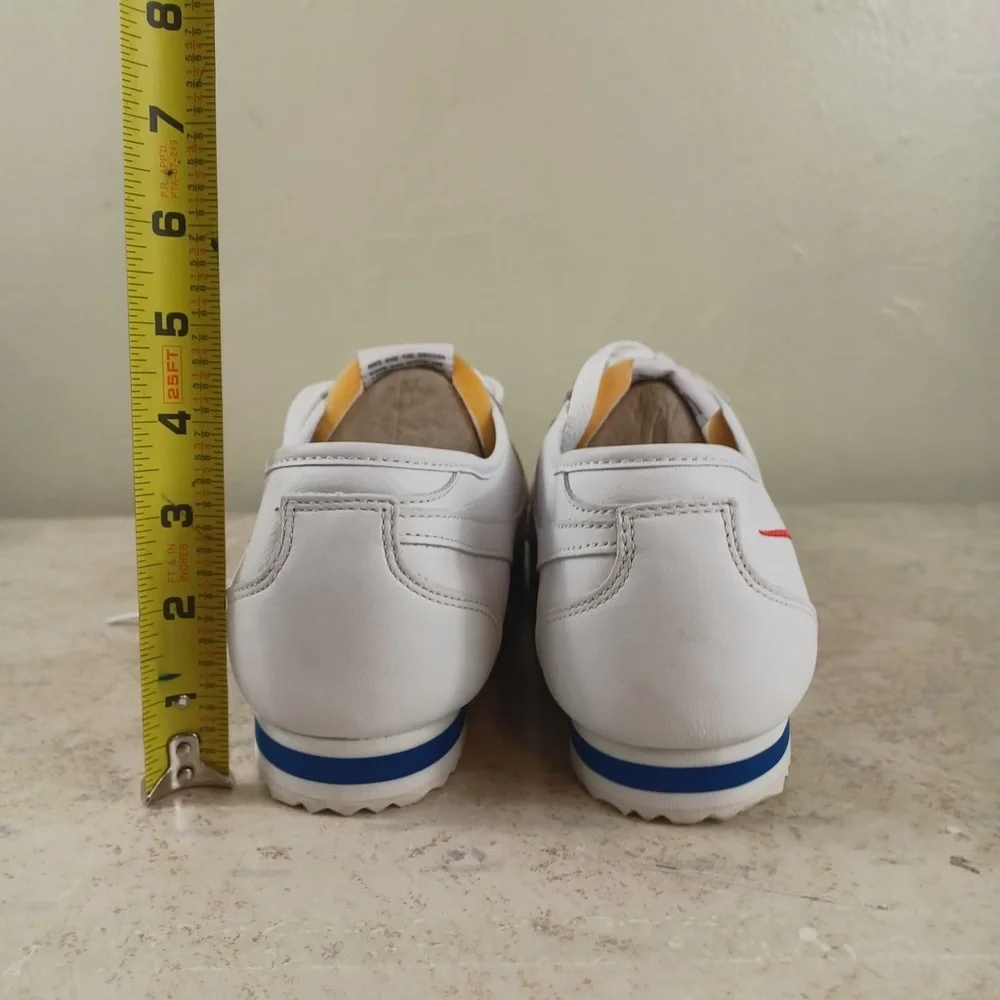 Nike White Sneakers with Red Swoosh and Blue Outsole Trim